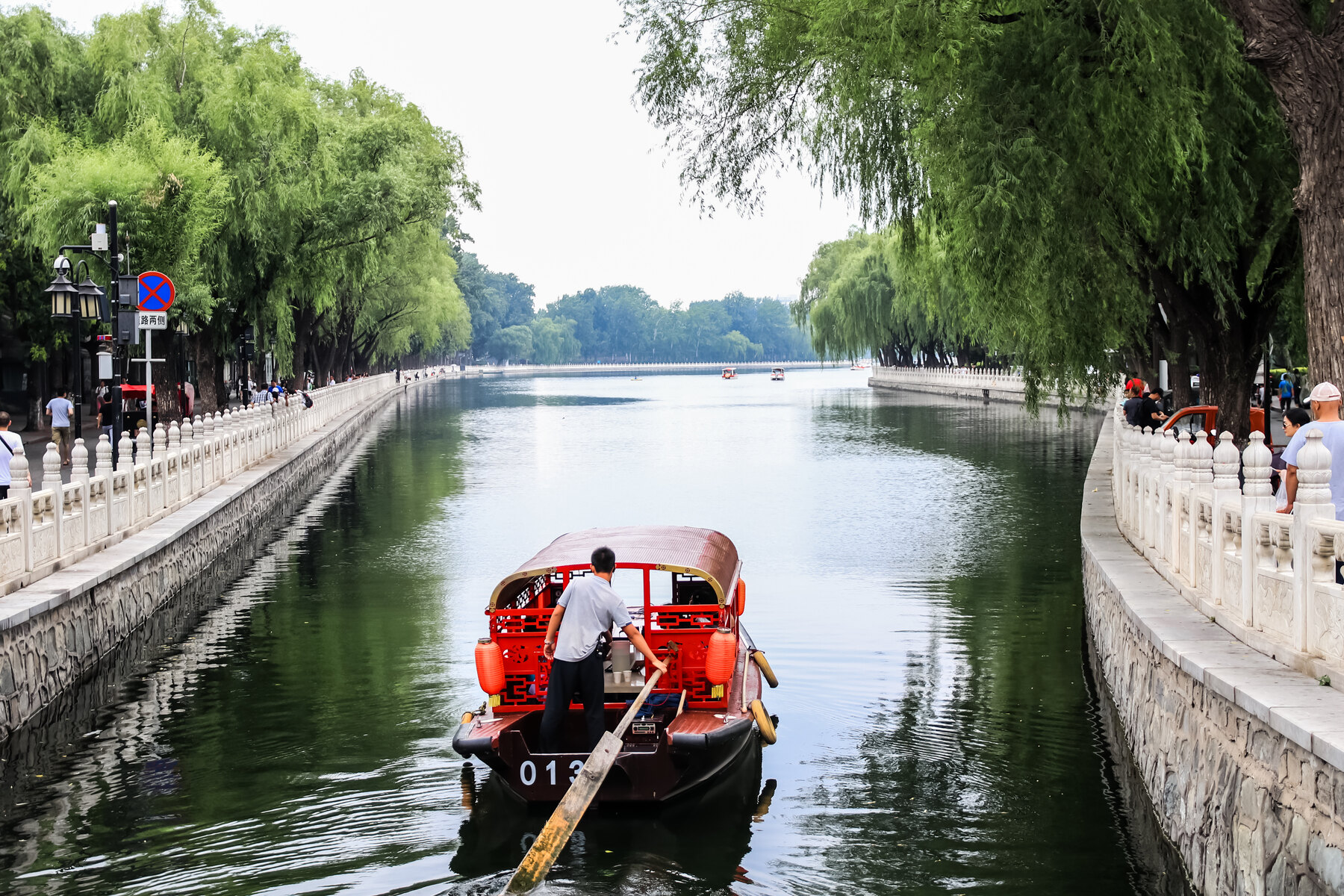 Street photography of a boat along a canal in Beijing