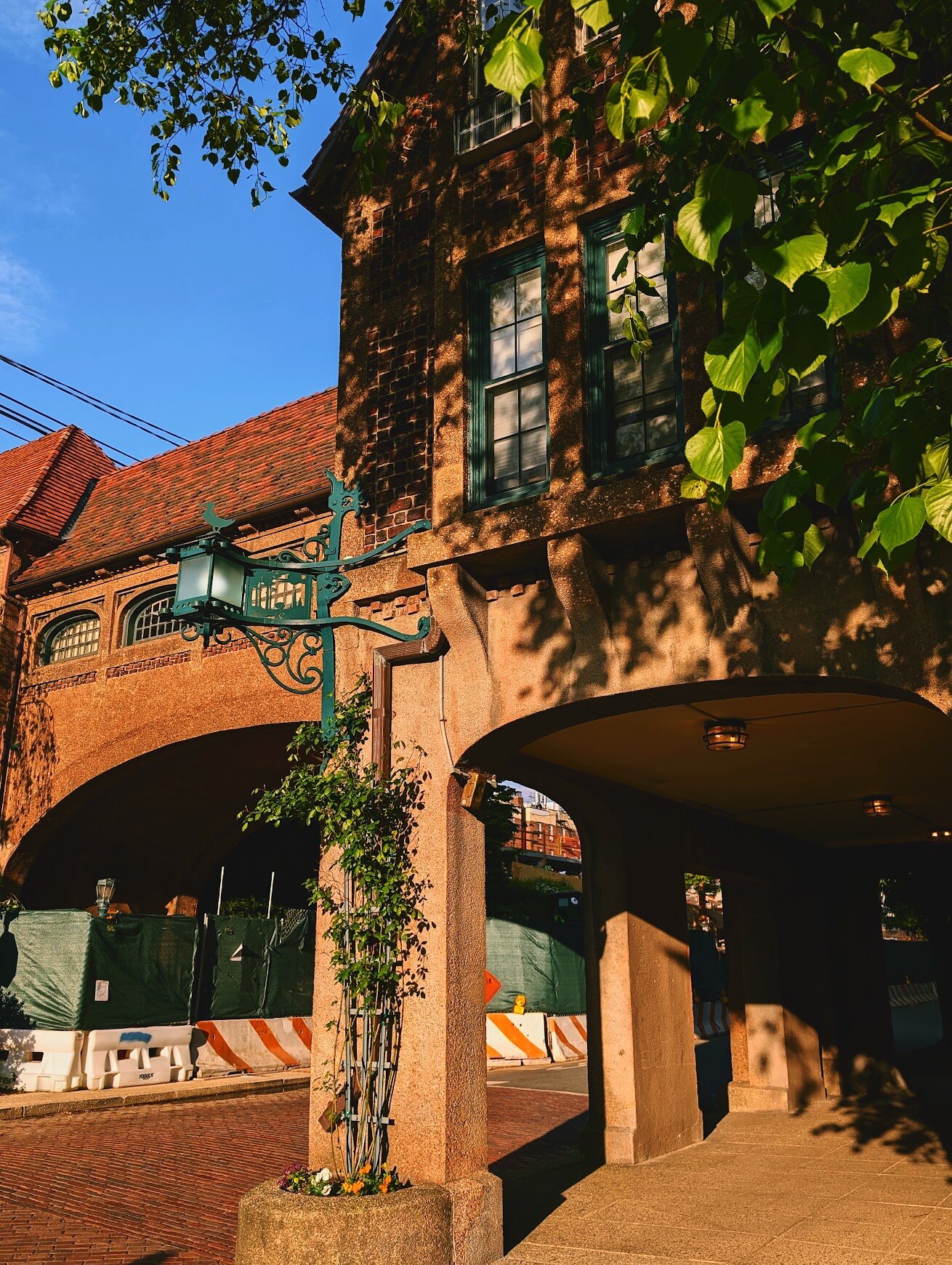 Brick archway building framed by greenery