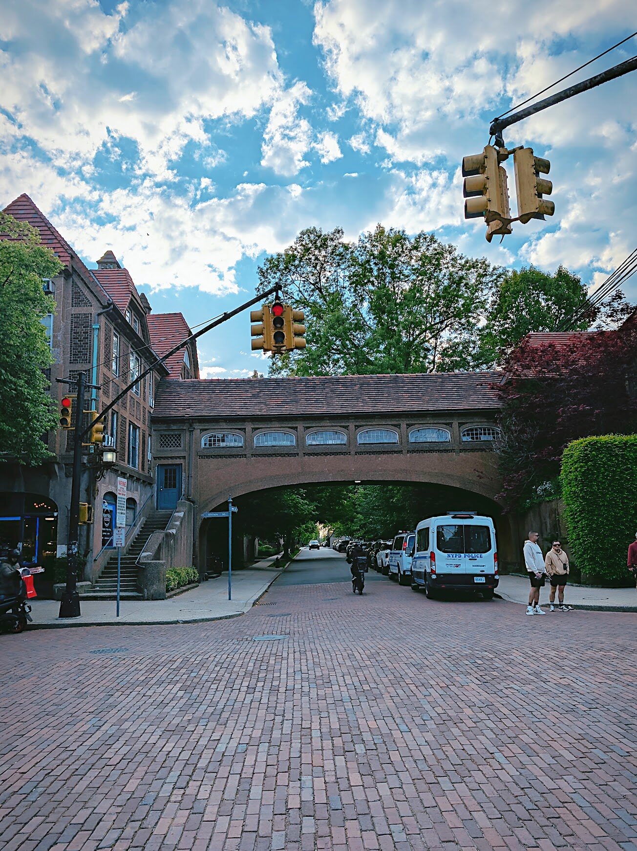 Brick street passing under an old stone bridge