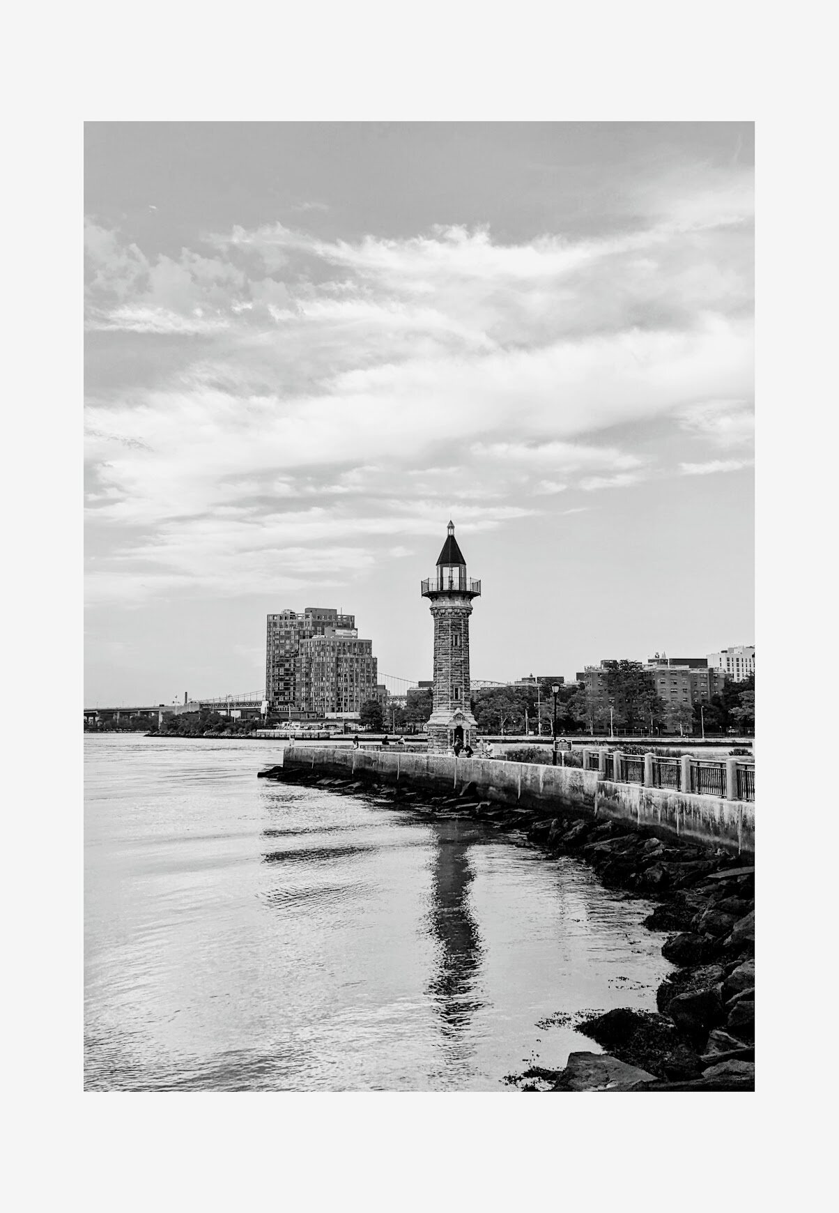 Black and white waterfront view with a lighthouse