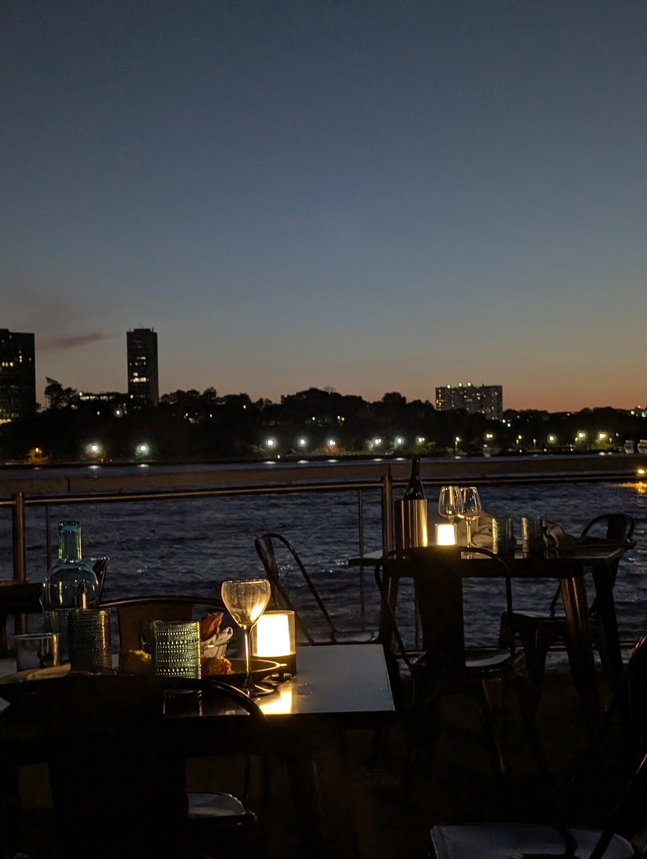 Rooftop restaurant table lit by candlelight at night