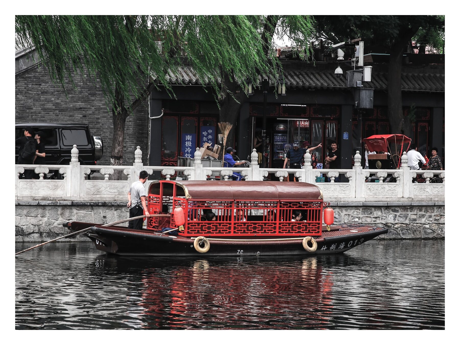 Traditional red tour boat on a canal in Beijing